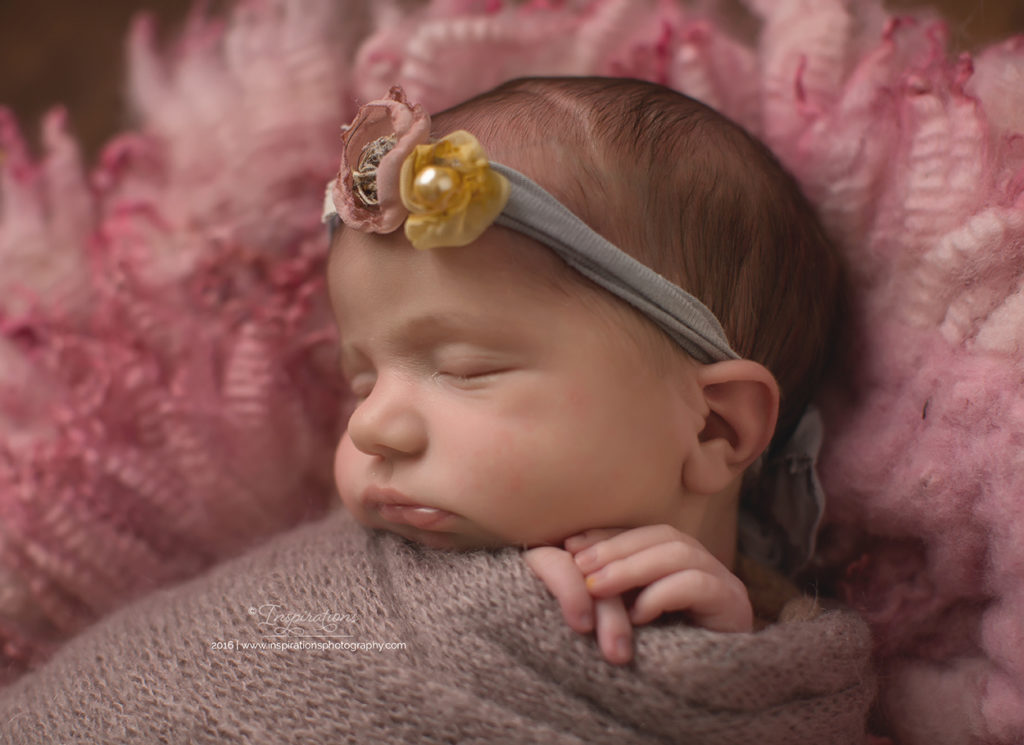 Newborn baby in grey and yellow headband
