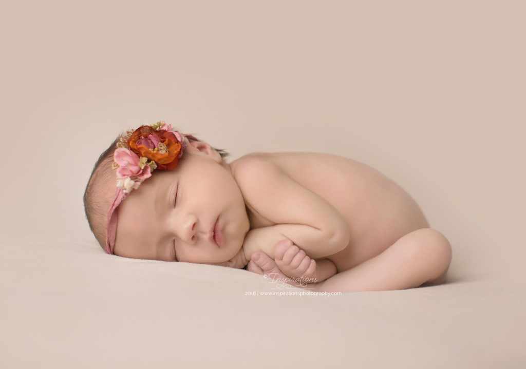Newborn in headband sleeping