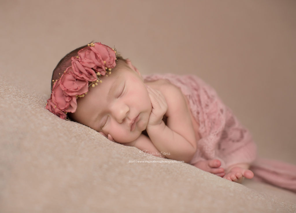 Newborn in headband sleeping