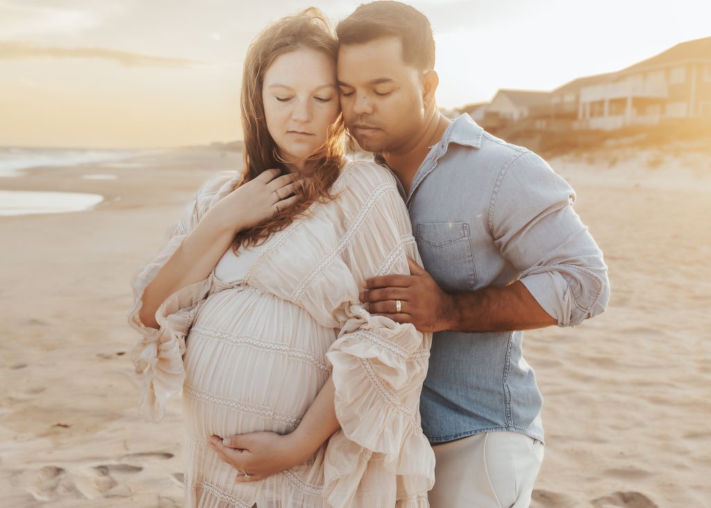 pregnant couple on the beach in Topsail Island NC